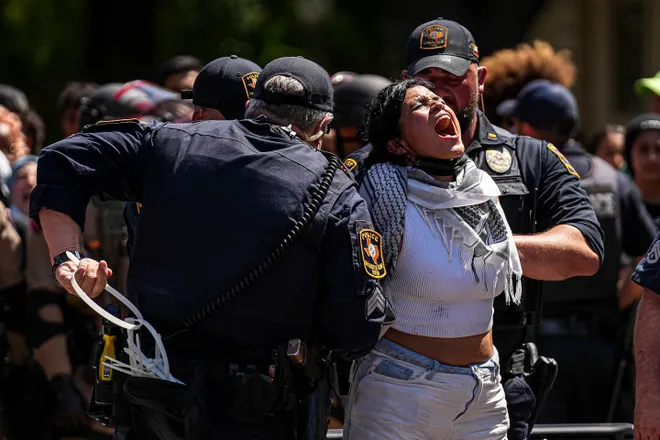 A protester yells "Free Palestine" as she is handcuffed by police during a demonstration in April at the University of Texas. In the wake of pro-Palestinian protests in the spring, and after an executive order by Gov. Greg Abbott, colleges across Texas have made changes to their free speech policies. Credit: Aaron E. Martinez