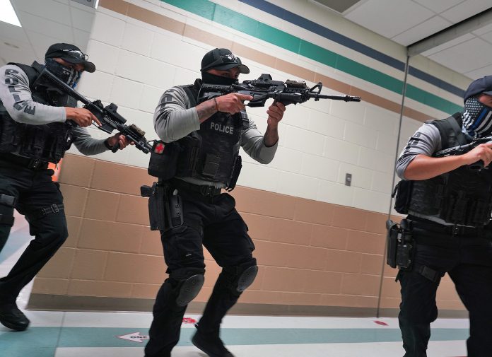 Members of the McAllen police Emergency Services Unit enter a classroom as they conduct a drill for the media during tactical training at Donna Wernecke Elementary School on Tuesday, July 12, 2022, in McAllen. (Joel Martinez | jmartinez@themonitor.com)