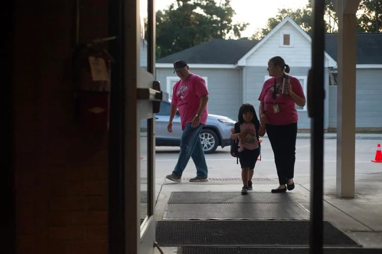 Teachers help a student into Fredonia Early Childhood Center as classes began around Nacogdoches ISD. Josh Edwards/The Daily Sentinel, file