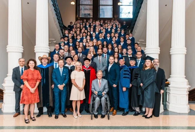 First year-students and staff at University of Austin meet with Texas governor Greg Abbott (center). / University of Austin