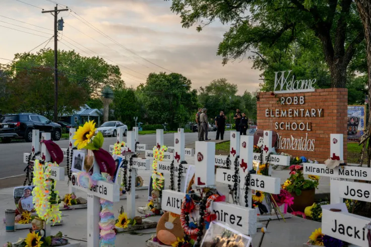 Law enforcement stand watch near a memorial dedicated to the 19 children and two adults murdered on May 24, 2022 during the mass shooting at Robb Elementary School Via Getty Images