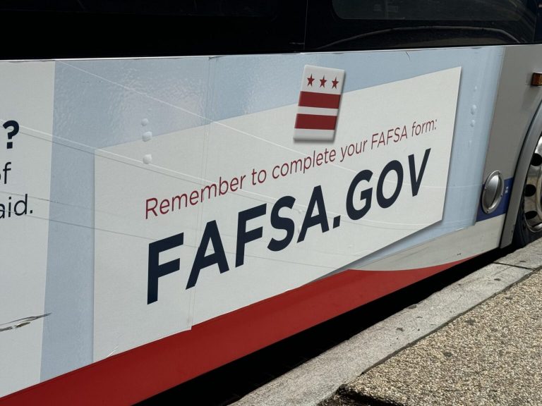 A sign reminding people to complete the Free Application for Federal Student Aid — better known as FAFSA — appears on a bus near Union Station in Washington, D.C. (Photo by Shauneen Miranda/States Newsroom)