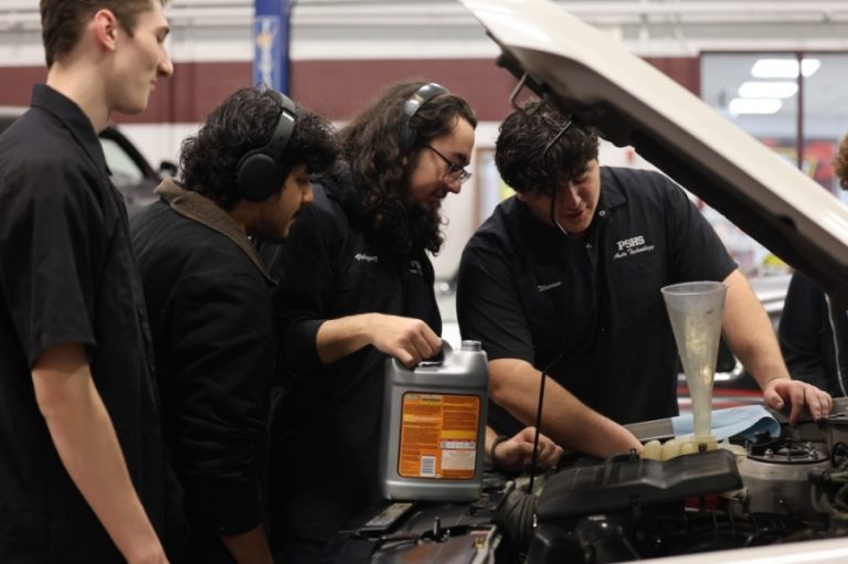 Students in Plano Senior High School's automotive program examine a car. (Courtesy Plano ISD)
