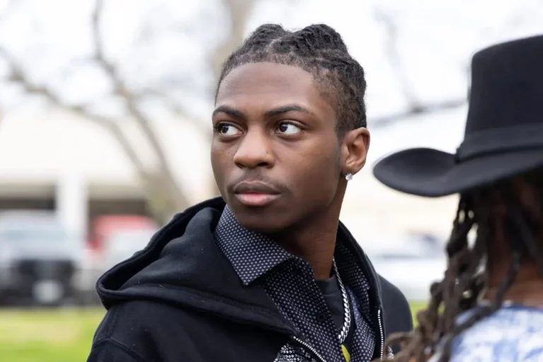Darryl George, an 18-year-old junior at Barbers Hill High School, stands near his mother before a bench trial on Thursday over whether his repeated suspensions violate the CROWN Act. Taken on Feb. 22, 2024.