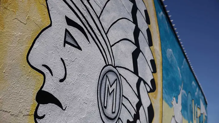 A mural for the Massapequa Chiefs school sports teams, where, according to media reports, the Trump administration has launched an investigation into New York officials threatening to withhold state funding for the town of Massapequa for failure to comply with a state mandate removing Native American names from school logos, is seen painted on a building next to the high school in Massapequa, New York, May 1, 2025.  (Reuters/Shannon Stapleton)
