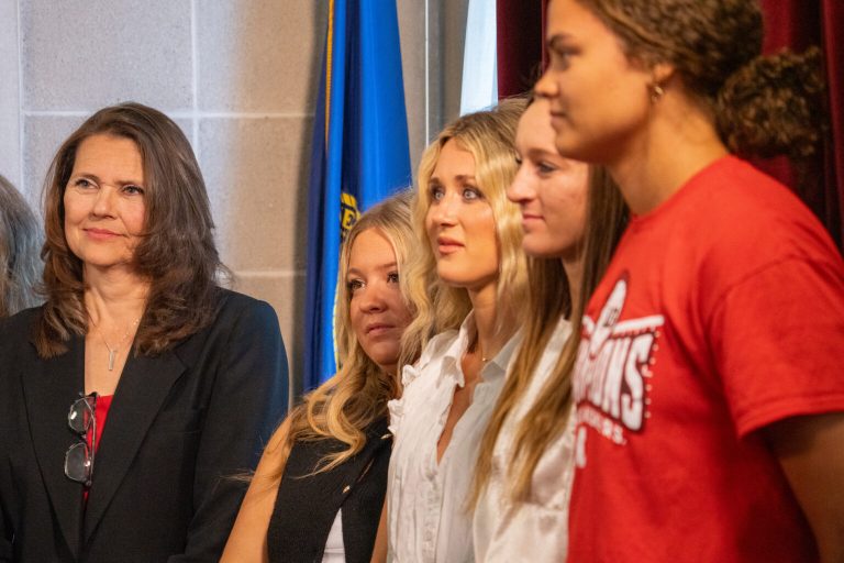 State Sen. Kathleen Kauth of the Millard area, left, joins with former student-athletes Payton McNabb (North Carolina) and Riley Gaines (University of Kentucky) and University of Nebraska-Lincoln student-athletes Jordy Bahl (Huskers softball) and Rebekah Allick (Huskers volleyball) for the signing of a bill led by Kauth to require student-athletes wishing to play in competitive sports in Nebraska to play on teams matching their sex at birth. June 4, 2025. (Zach Wendling/Nebraska Examiner)